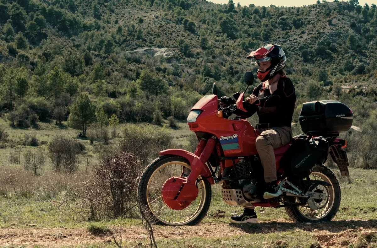 Rider on a red Honda Dominator in the Spanish hills